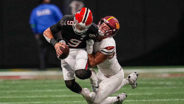 Oct 15, 2023; Atlanta, Georgia, USA; Atlanta Falcons quarterback Desmond Ridder (9) is tackled for a loss by Washington Commanders defensive end Casey Toohill (95) during the second half at Mercedes-Benz Stadium. Mandatory Credit: Dale Zanine-USA TODAY Sports